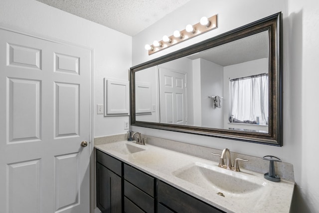 bathroom featuring vanity and a textured ceiling