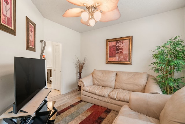 living room featuring ceiling fan and light hardwood / wood-style floors