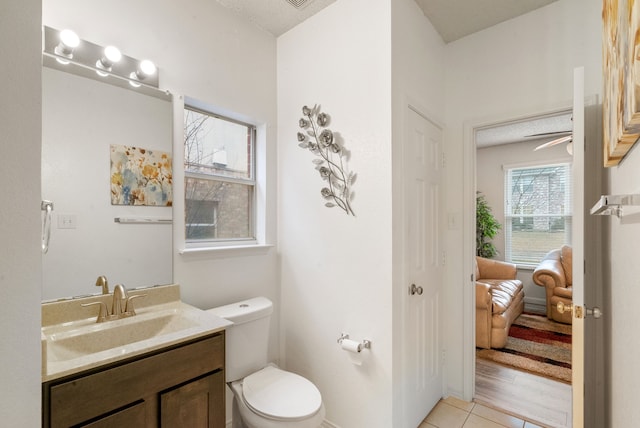 bathroom featuring vanity, toilet, and tile patterned flooring