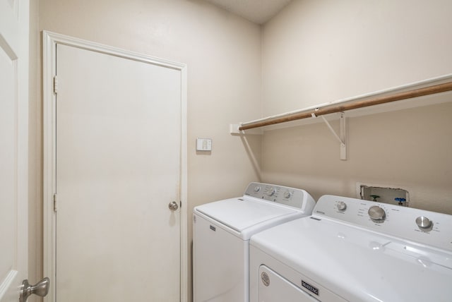 clothes washing area with separate washer and dryer