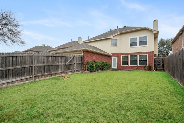 rear view of property with a yard