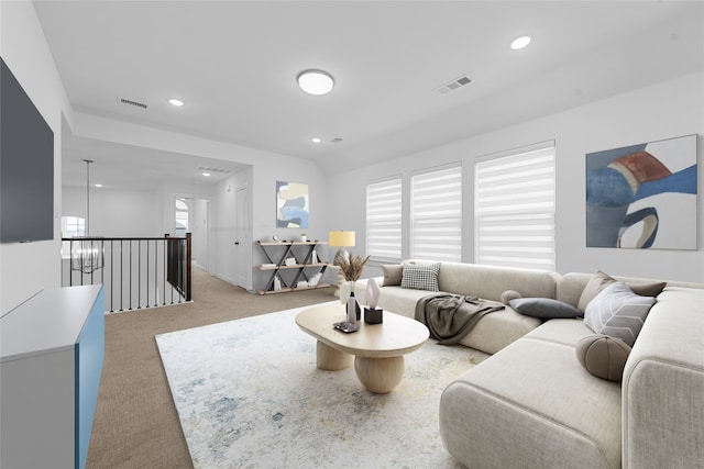 carpeted living room with lofted ceiling