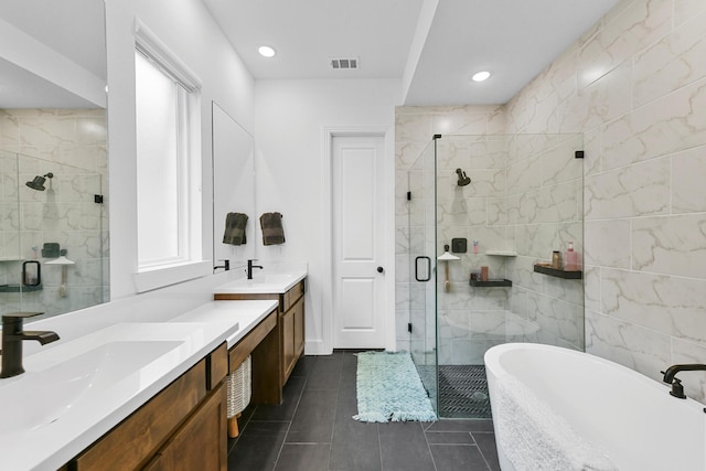 bathroom featuring vanity, tile patterned floors, tile walls, and separate shower and tub