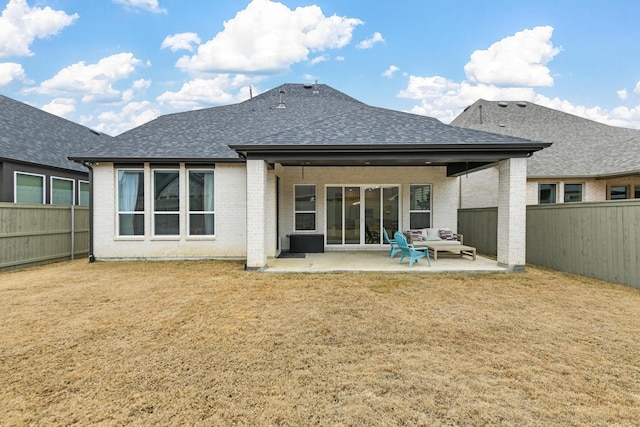 rear view of house featuring a patio area and a lawn