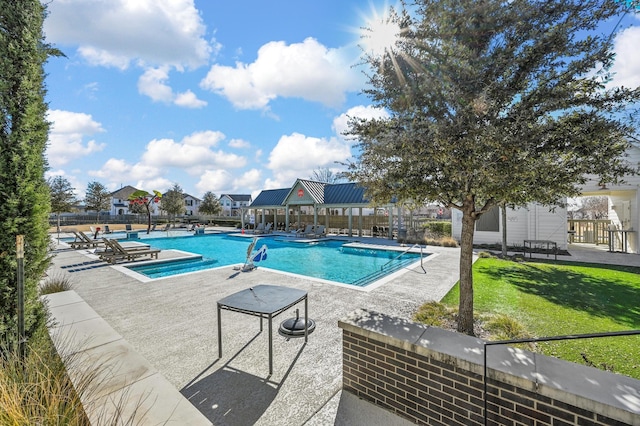 view of pool featuring a lawn and a patio