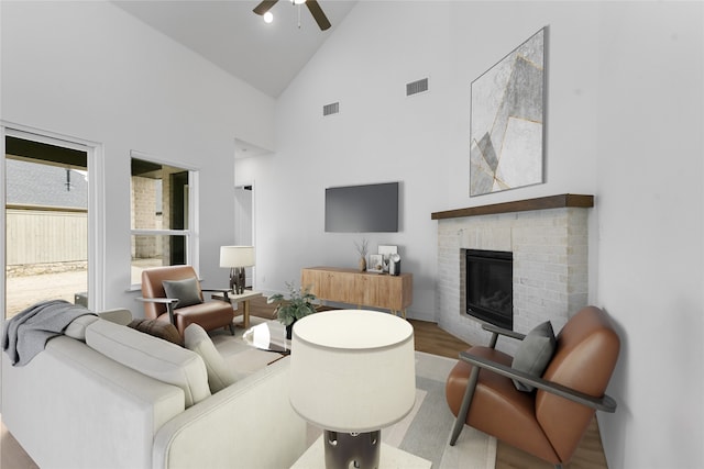 living room featuring ceiling fan, high vaulted ceiling, a fireplace, and hardwood / wood-style floors