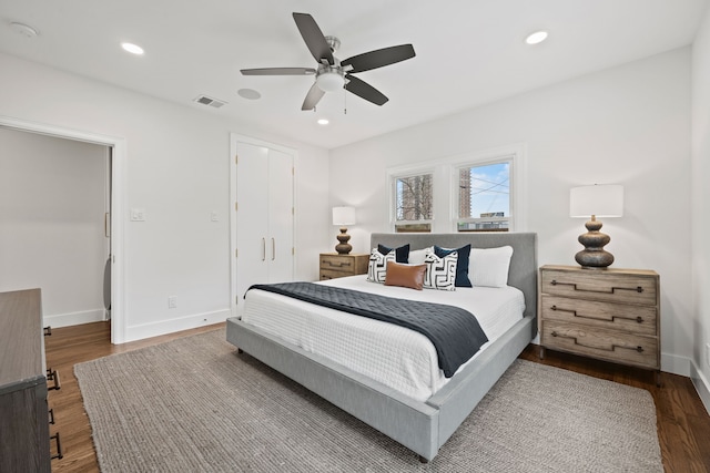 bedroom with recessed lighting, wood finished floors, visible vents, and baseboards