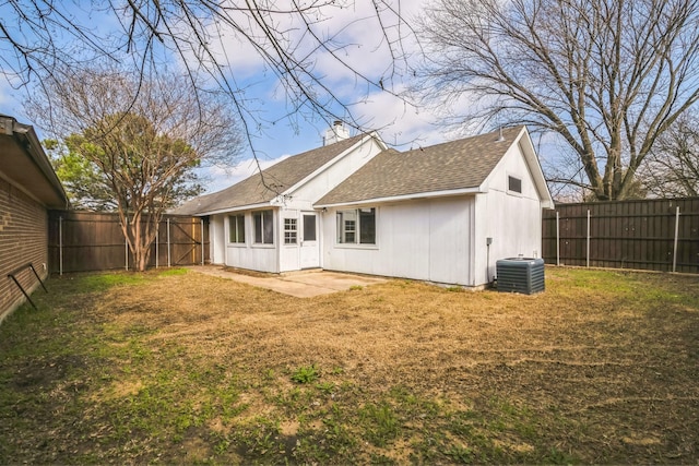 rear view of house with a yard and central AC unit