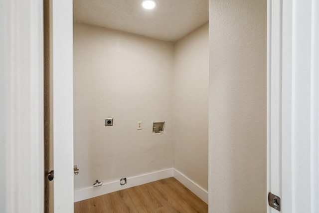 clothes washing area with gas dryer hookup, washer hookup, wood-type flooring, and hookup for an electric dryer