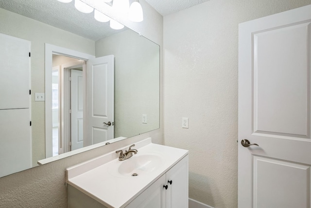 bathroom with vanity and a textured ceiling