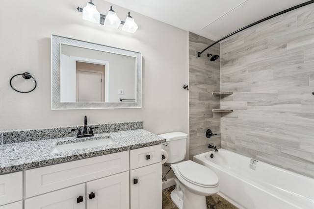 full bathroom with vanity, tiled shower / bath combo, and toilet