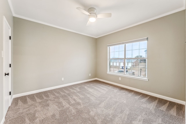 carpeted empty room with ornamental molding and ceiling fan