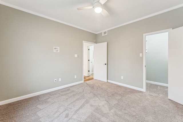 carpeted empty room with crown molding and ceiling fan