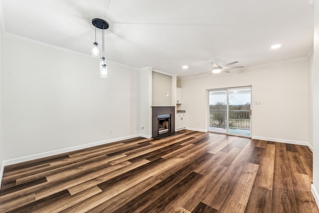 unfurnished living room featuring ornamental molding, dark hardwood / wood-style floors, and ceiling fan