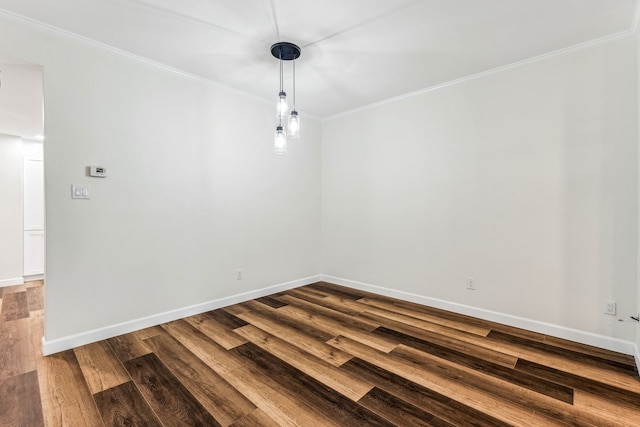 spare room with crown molding and wood-type flooring