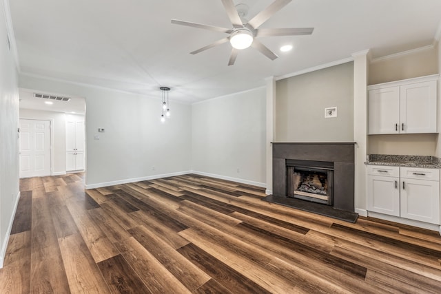 unfurnished living room featuring crown molding, dark hardwood / wood-style floors, and ceiling fan