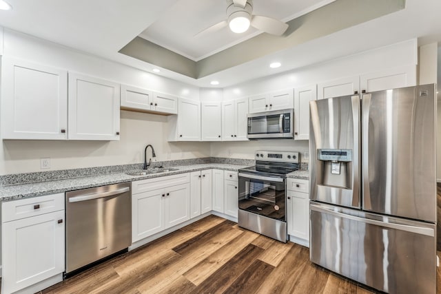 kitchen with sink, white cabinets, and appliances with stainless steel finishes