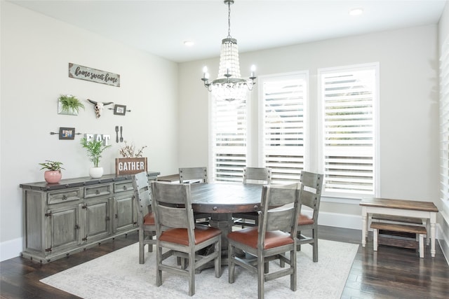 dining area featuring an inviting chandelier, dark wood-type flooring, and plenty of natural light