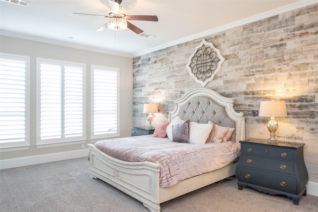 carpeted bedroom featuring crown molding and ceiling fan