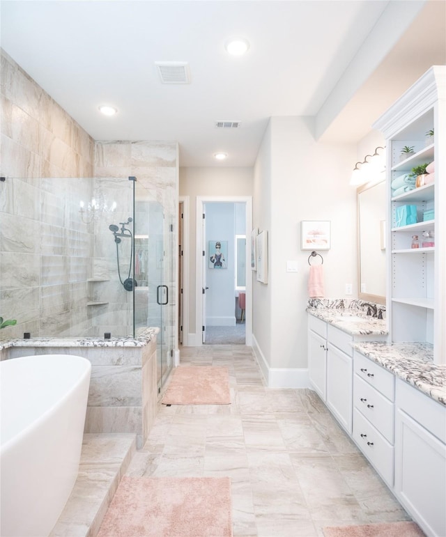 bathroom with vanity and shower with separate bathtub