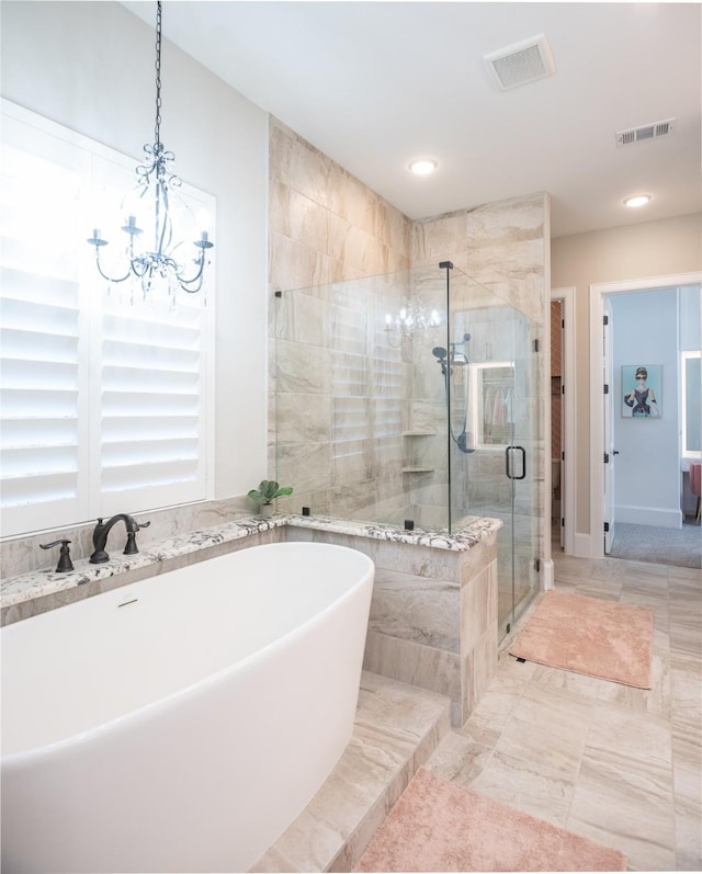 bathroom with an inviting chandelier and independent shower and bath