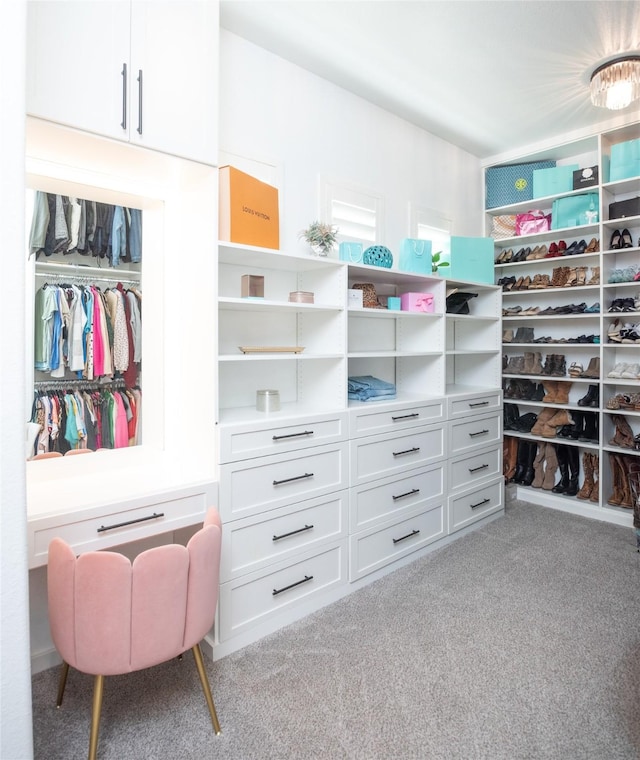 walk in closet featuring light carpet