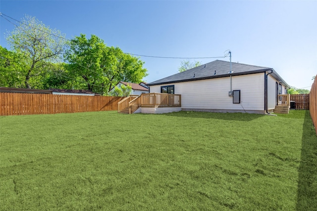 back of property featuring a lawn and a deck