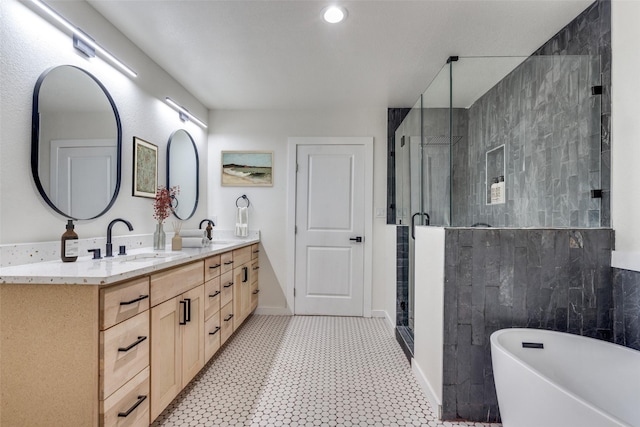 bathroom with vanity and independent shower and bath