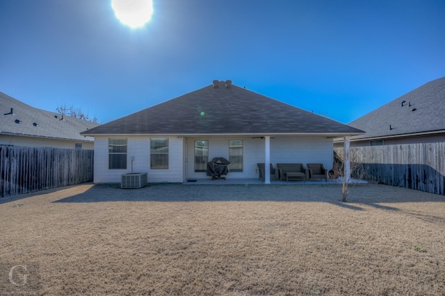 rear view of property featuring central AC and a patio area