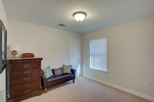 sitting room with light colored carpet