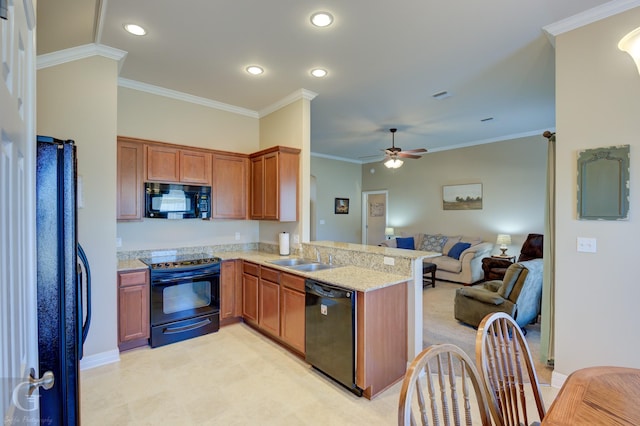 kitchen with sink, light stone counters, crown molding, kitchen peninsula, and black appliances