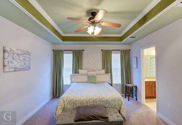 carpeted bedroom featuring multiple windows, ornamental molding, and a raised ceiling