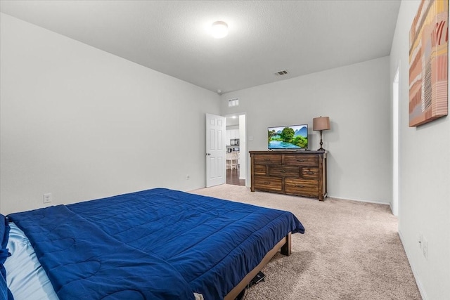 carpeted bedroom with a textured ceiling