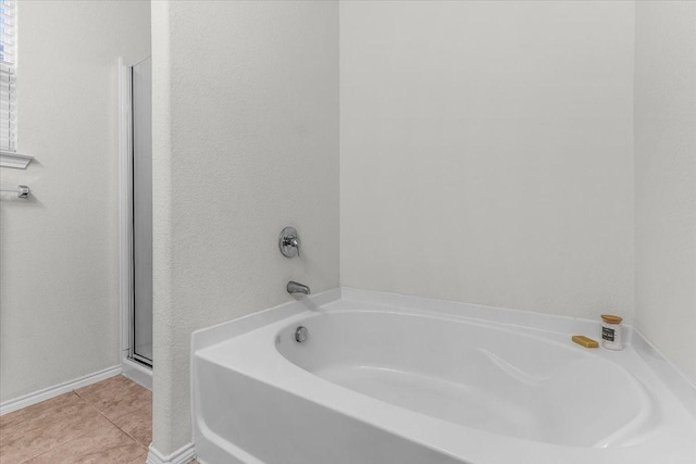 bathroom featuring a bath and tile patterned floors