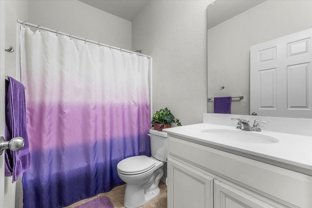 bathroom with vanity, a shower with shower curtain, and toilet