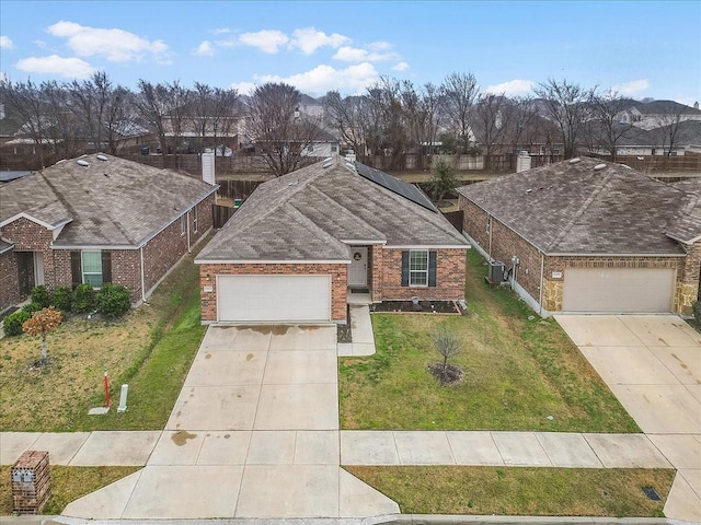 ranch-style house with a garage and a front yard