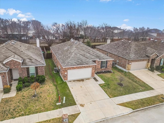 view of front of house featuring a garage and a front lawn