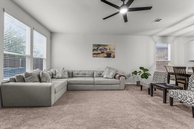 carpeted living room featuring ceiling fan