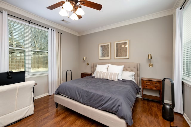 bedroom with crown molding, dark wood-type flooring, and ceiling fan