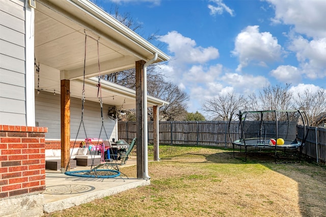 view of yard with a trampoline, a patio area, and outdoor lounge area