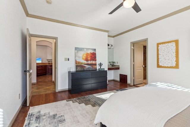 bedroom featuring baseboards, dark wood finished floors, a ceiling fan, and ornamental molding