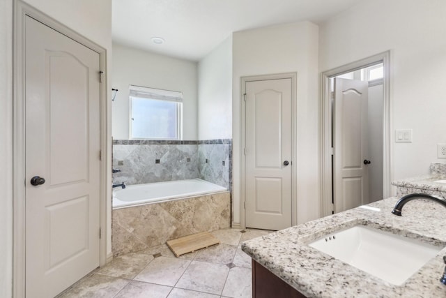 full bath featuring a bath, tile patterned floors, and vanity