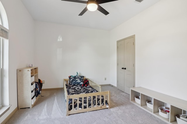 sitting room featuring carpet flooring, baseboards, and a ceiling fan