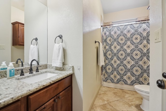 bathroom featuring tile patterned flooring, baseboards, toilet, shower / tub combo with curtain, and vanity