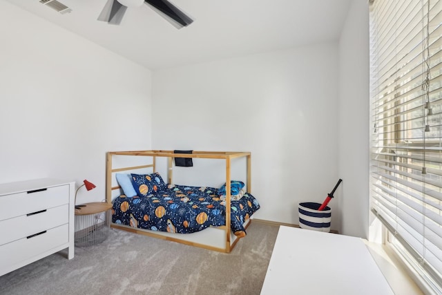 carpeted bedroom featuring visible vents and a ceiling fan