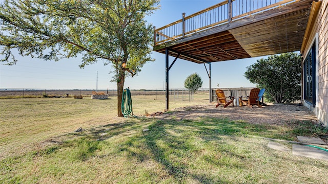 view of yard featuring a rural view and fence