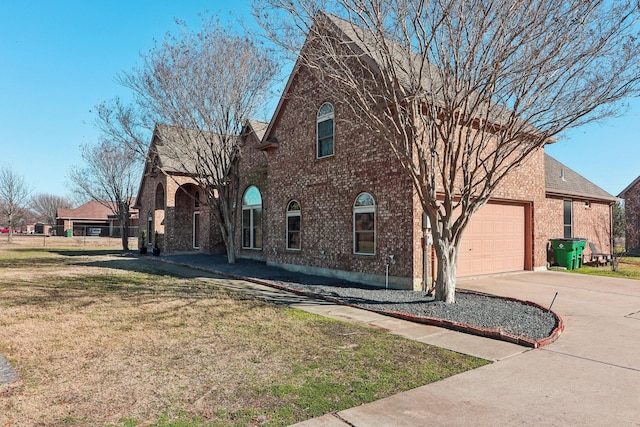 view of front facade with a garage and a front lawn