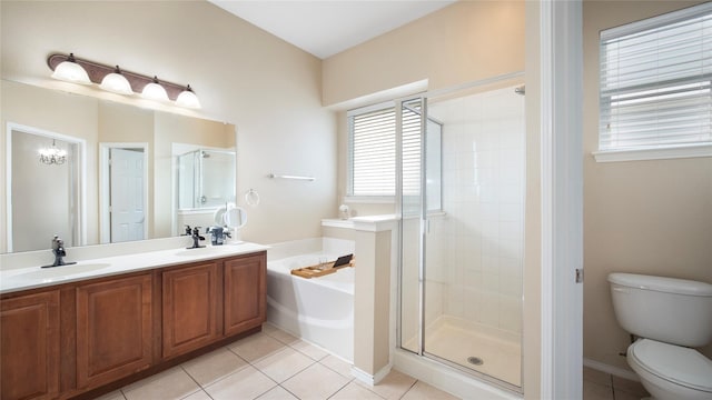 full bathroom featuring tile patterned flooring, vanity, shower with separate bathtub, and toilet