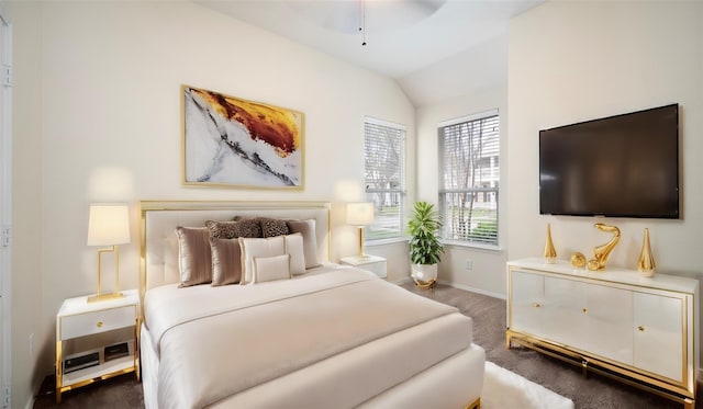 bedroom featuring dark colored carpet and vaulted ceiling