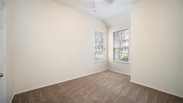 unfurnished room featuring ceiling fan, light colored carpet, and lofted ceiling